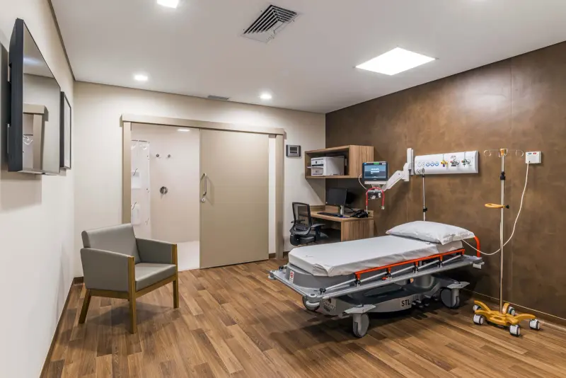 Leito do pronto-socorro do Hospital Vila Nova Star, com maca e piso de madeira